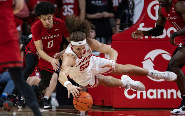 Nebraska's Josiah Allick dives for a loose ball against Rutgers' Derek Simpson on March 3, 2024, on Senior Day in Lincoln.